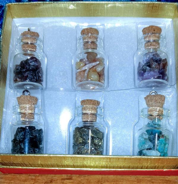 6 sample glass bottles of gem stones